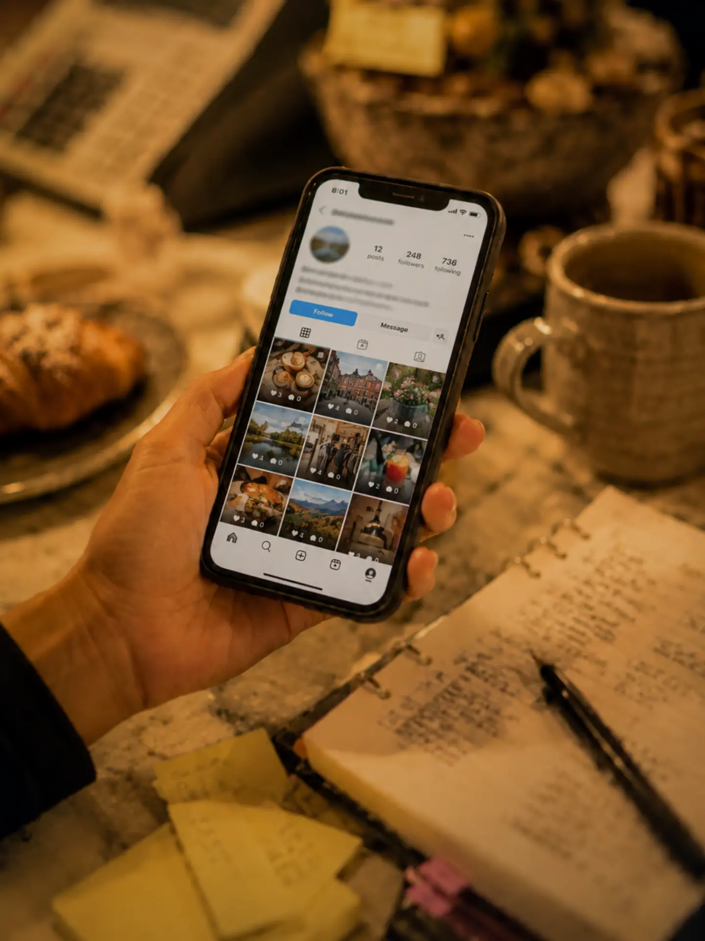 A business owner reviewing a social media account on a phone