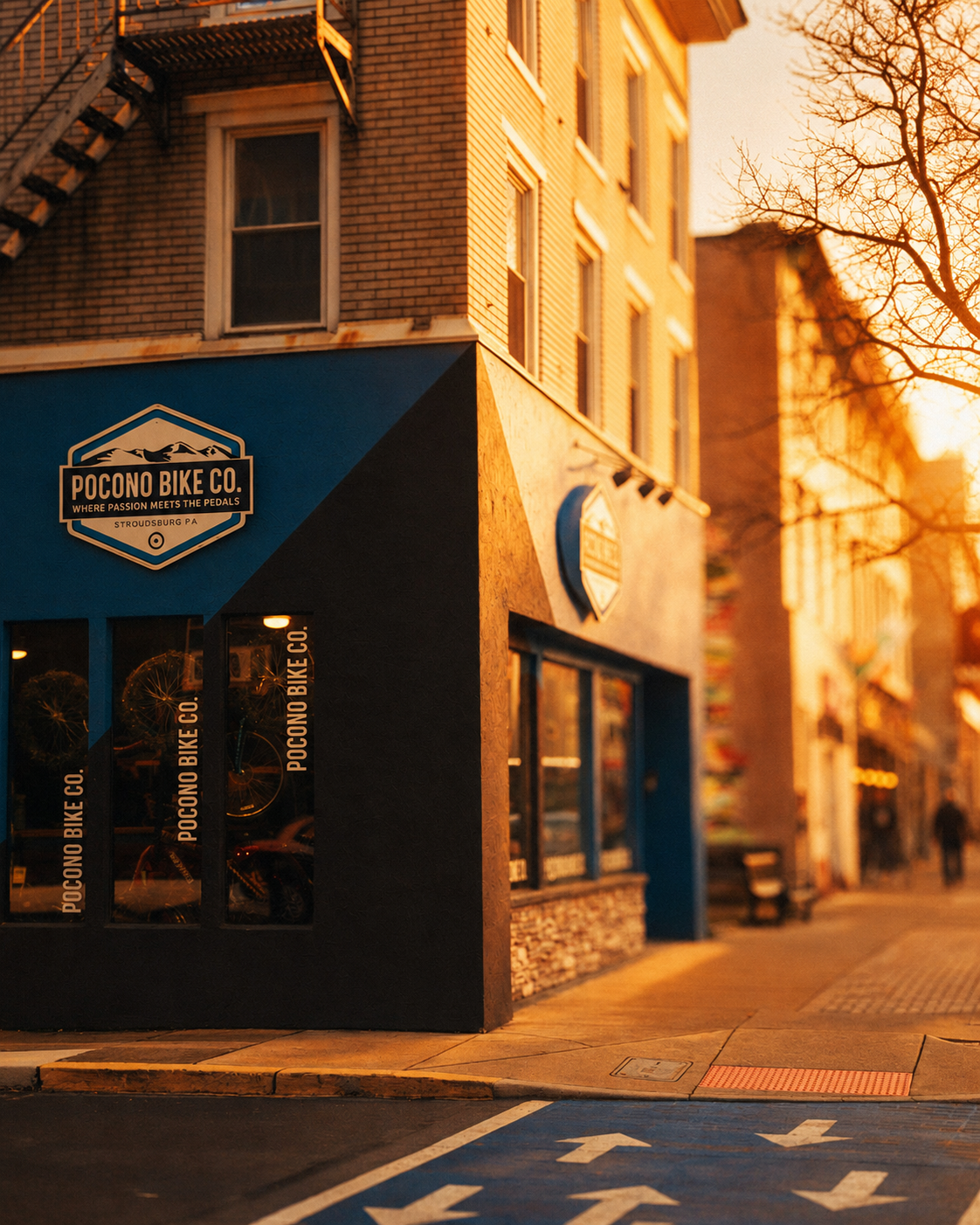 Pocono Bike Co. storefront on a Stroudsburg corner at golden hour